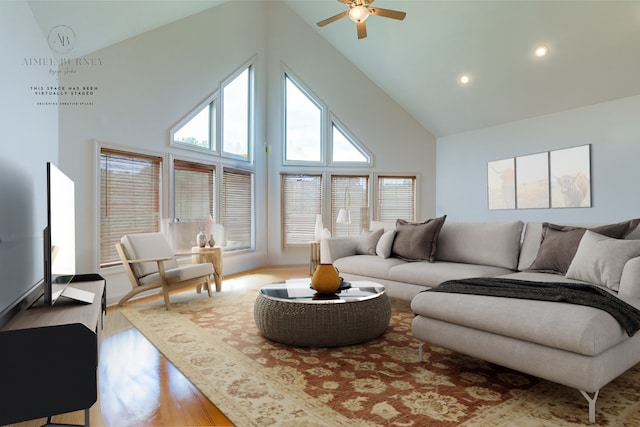 living room featuring high vaulted ceiling, ceiling fan, and light wood-type flooring