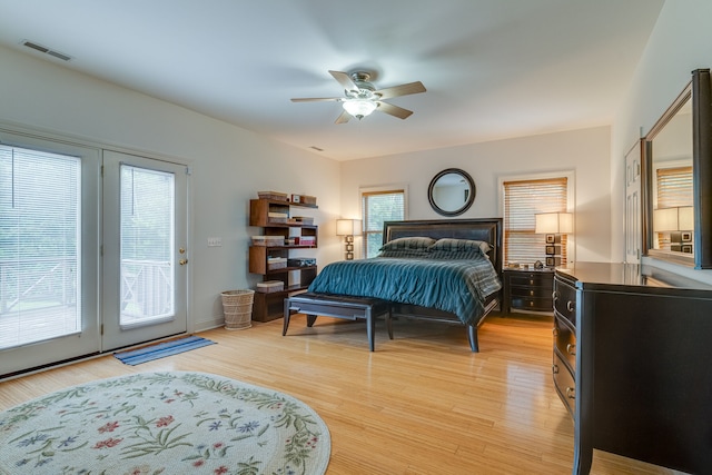 bedroom featuring multiple windows, access to outside, light hardwood / wood-style flooring, and ceiling fan