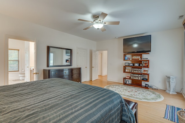 bedroom with ceiling fan, light hardwood / wood-style floors, and ensuite bathroom