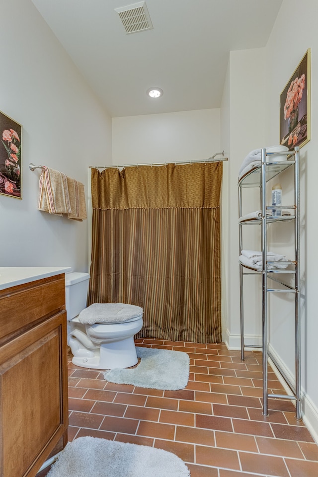 bathroom featuring toilet and vanity