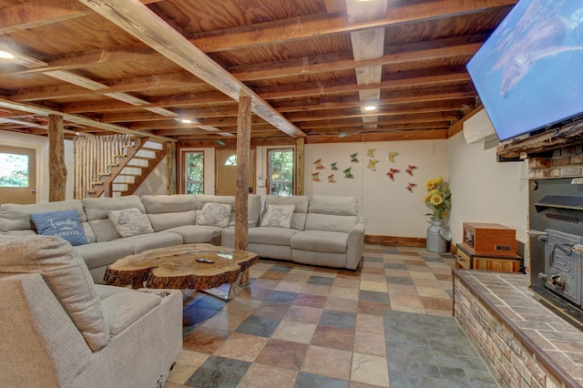 living room with a wall mounted AC, a wood stove, and beamed ceiling