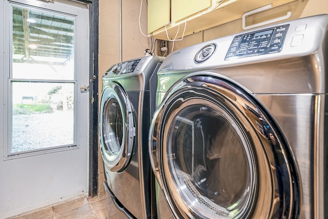 laundry room with light tile patterned floors and separate washer and dryer