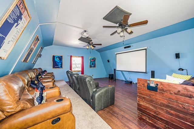 cinema with dark wood-type flooring, ceiling fan, and lofted ceiling