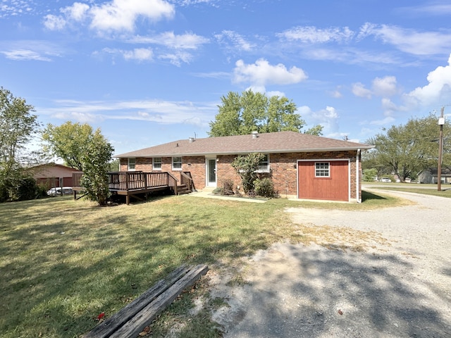 back of property with a lawn and a deck