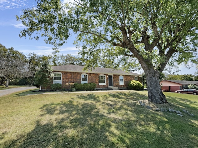 ranch-style house with a garage and a front yard