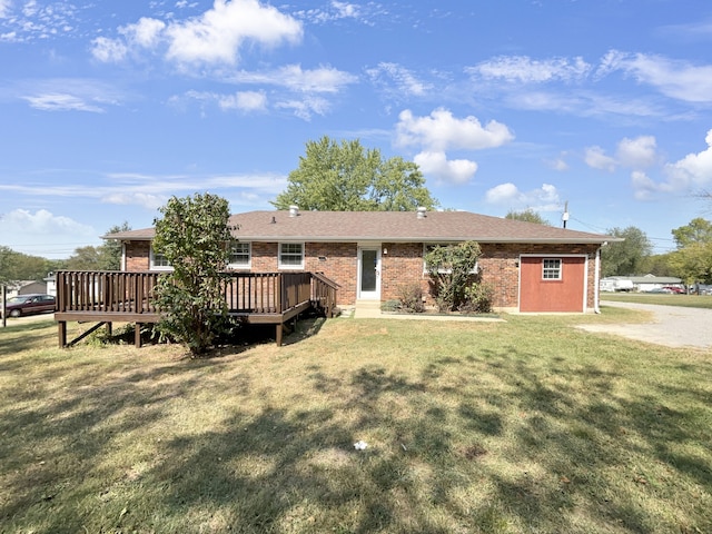 ranch-style house featuring a wooden deck and a front yard