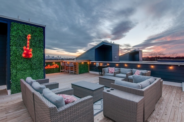 deck at dusk featuring an outdoor living space