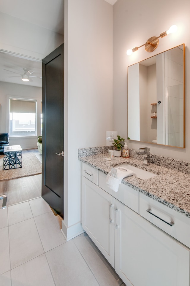 bathroom featuring tile patterned floors, ceiling fan, and vanity