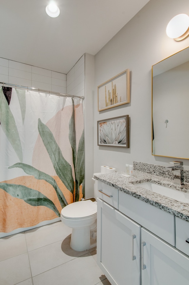 bathroom featuring vanity, toilet, curtained shower, and tile patterned floors