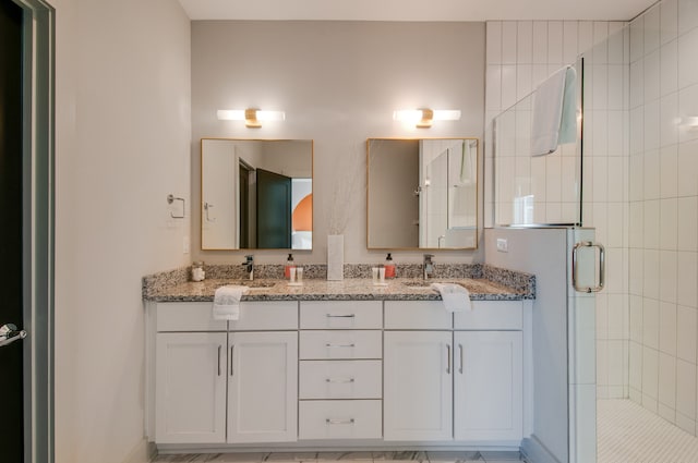 bathroom featuring an enclosed shower and vanity