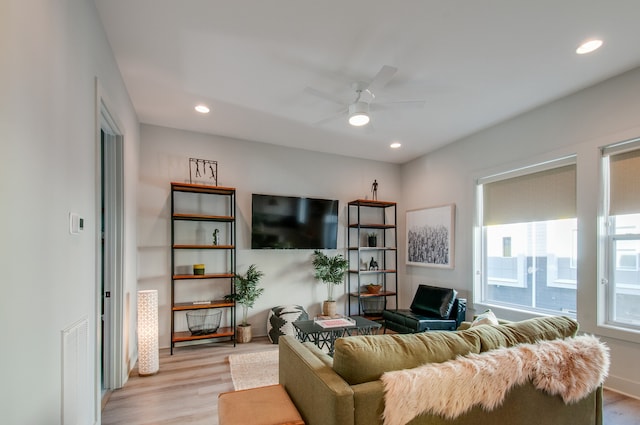 living room with light wood-type flooring and ceiling fan