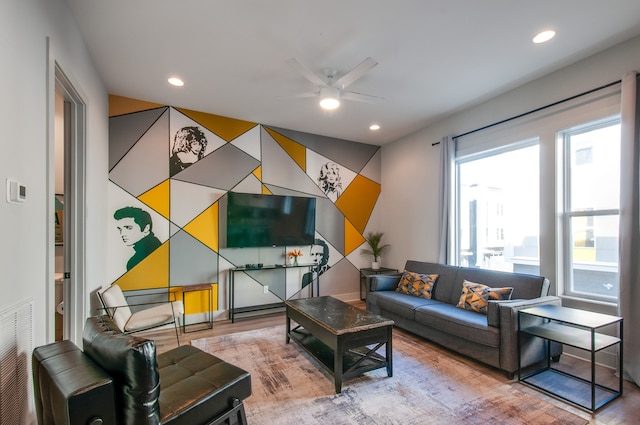 living room with ceiling fan and wood-type flooring