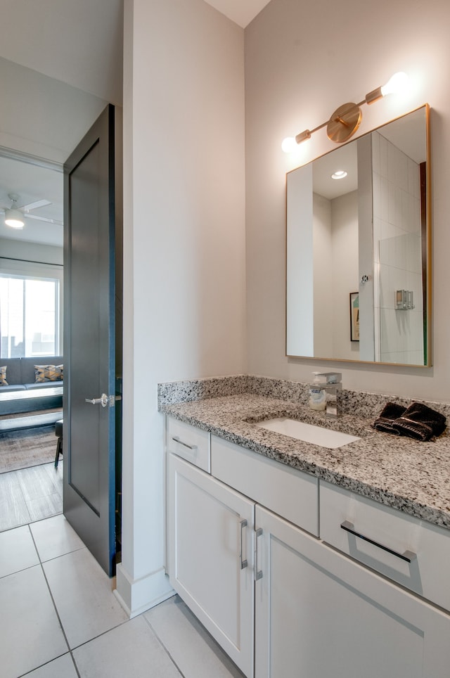 bathroom featuring vanity, ceiling fan, and tile patterned flooring