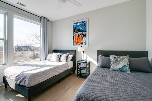 bedroom with concrete floors and ceiling fan