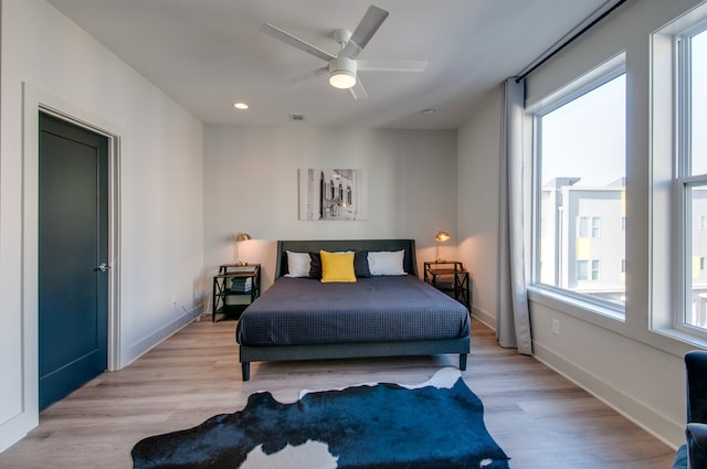 bedroom featuring ceiling fan and light hardwood / wood-style floors