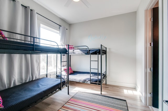 bedroom with light hardwood / wood-style flooring and ceiling fan