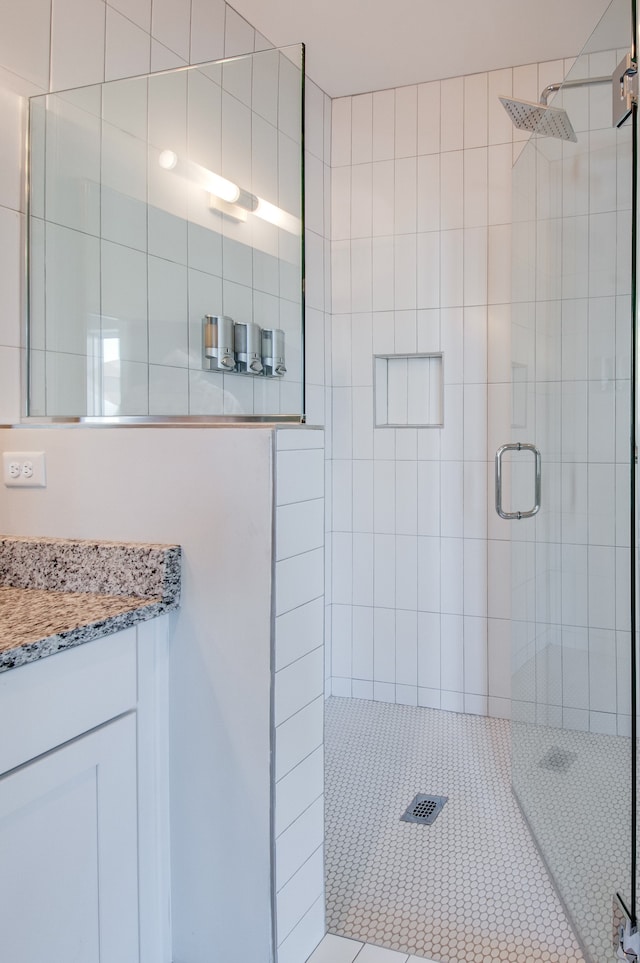 bathroom featuring vanity and an enclosed shower