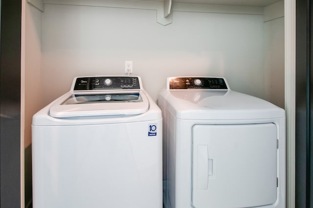 clothes washing area with independent washer and dryer