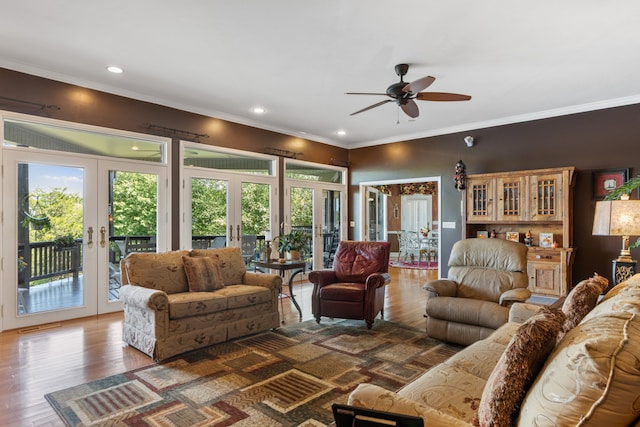 living room with hardwood / wood-style floors, ceiling fan, ornamental molding, and french doors