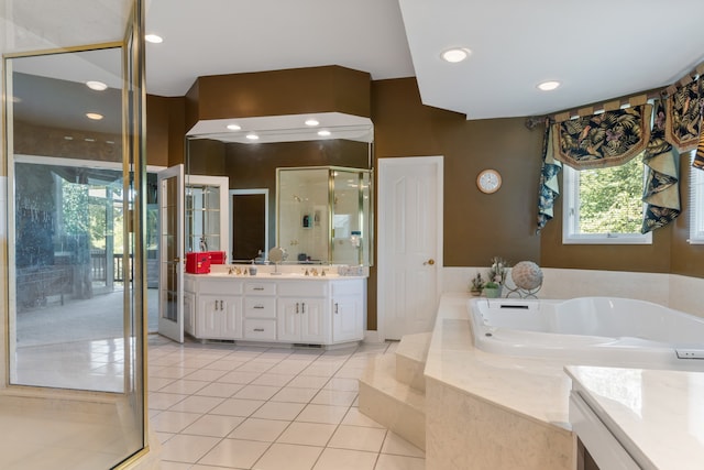 bathroom with vanity, tile patterned flooring, and shower with separate bathtub