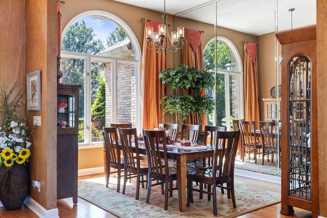 dining space with light wood-type flooring and a wealth of natural light