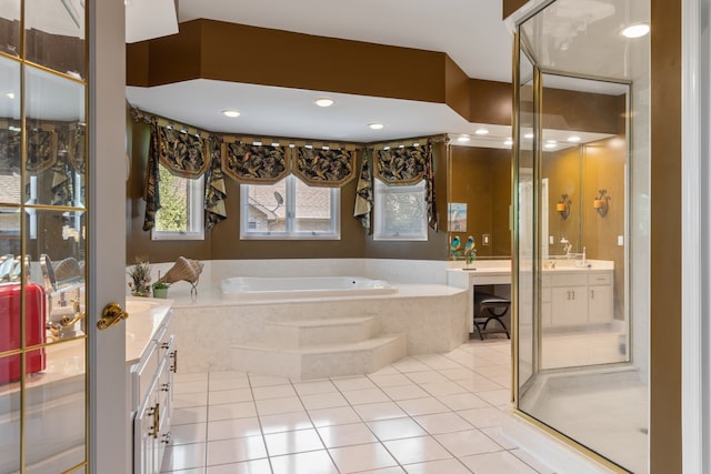 bathroom featuring plus walk in shower, tile patterned floors, and vanity