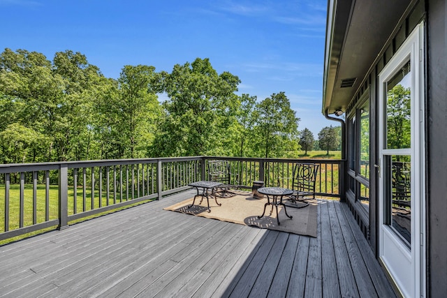 wooden terrace with a lawn