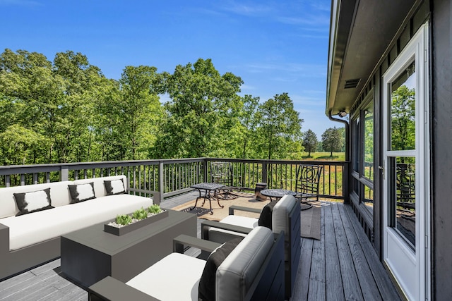 wooden terrace featuring outdoor lounge area