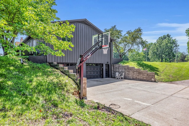 view of property exterior with a garage and a lawn