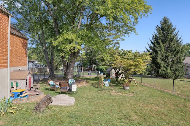 view of yard with an outdoor fire pit
