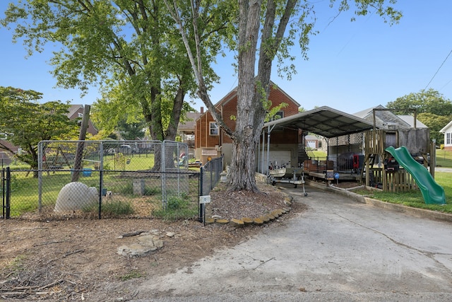 view of yard featuring a playground and a carport