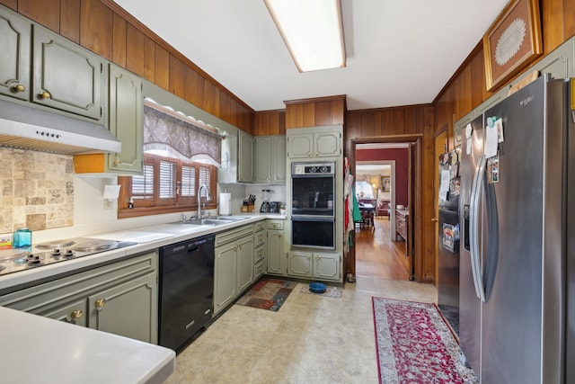 kitchen featuring green cabinets, ornamental molding, light tile patterned floors, black appliances, and sink