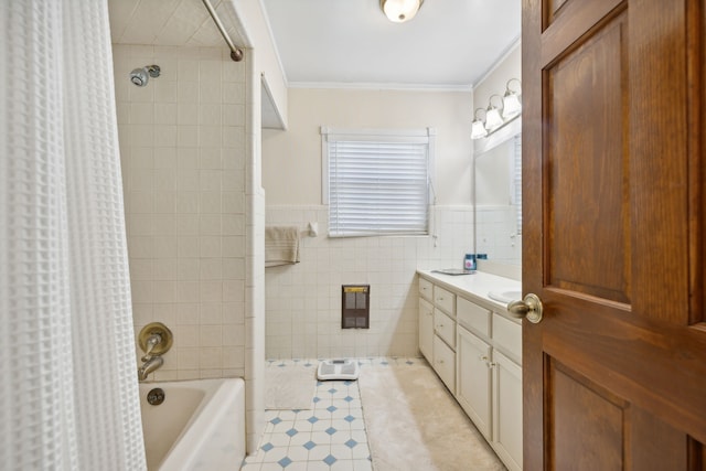 bathroom featuring vanity, shower / bath combo with shower curtain, ornamental molding, and tile walls