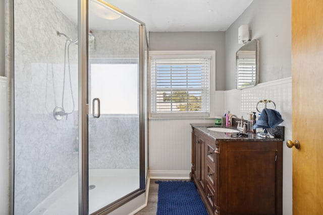 bathroom with vanity, wood-type flooring, and walk in shower
