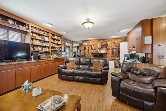 living room featuring light wood-type flooring and brick wall