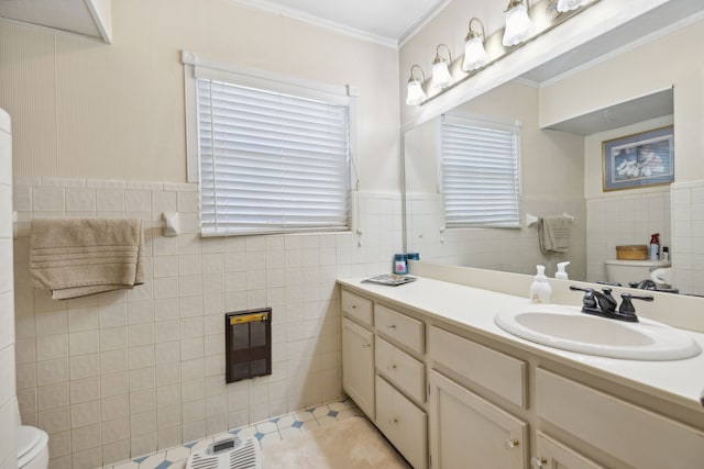 bathroom with crown molding, tile patterned floors, toilet, tile walls, and vanity