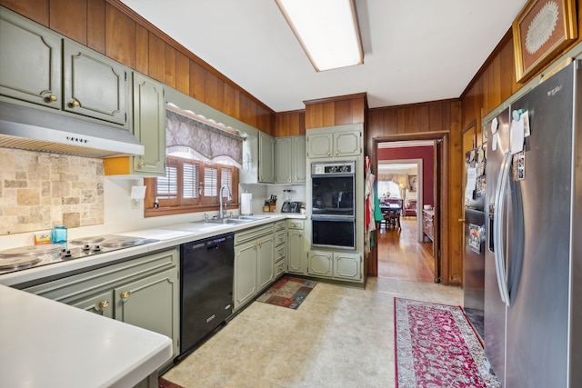 kitchen with green cabinets, stainless steel fridge, cooktop, dishwasher, and sink