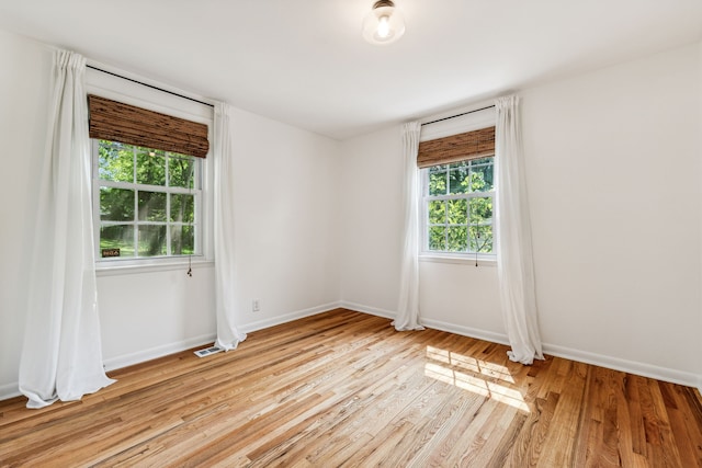 spare room with light wood-type flooring