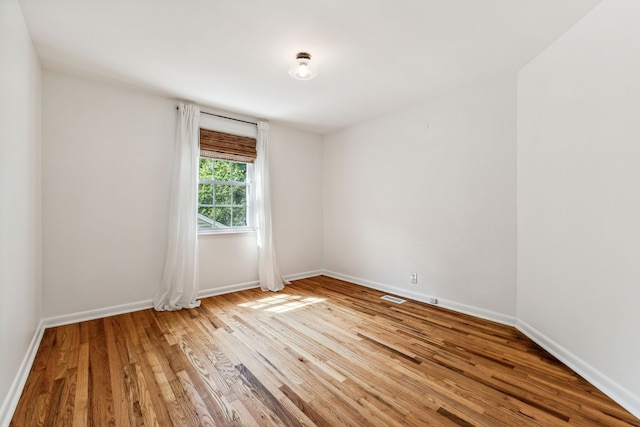 spare room featuring light hardwood / wood-style floors