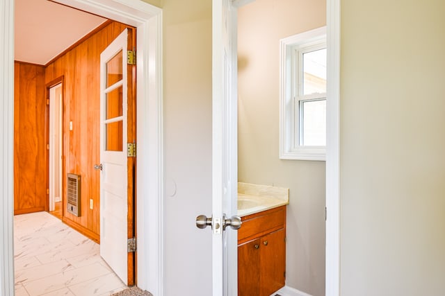 hall with wooden walls and heating unit