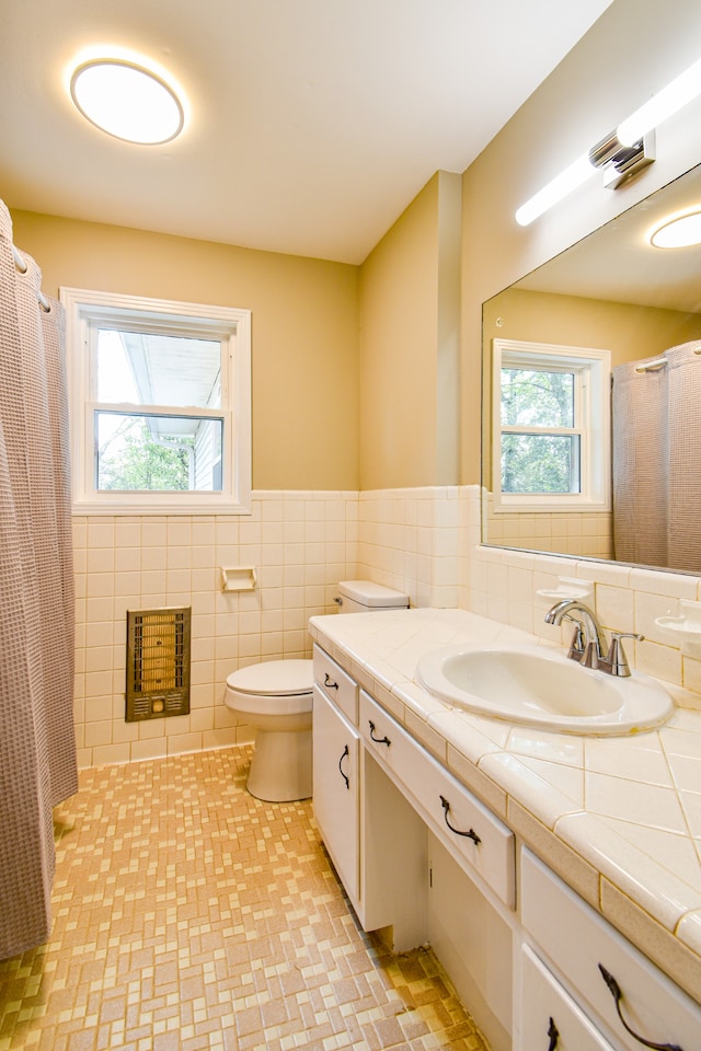 bathroom featuring vanity, tile walls, toilet, a shower with curtain, and heating unit