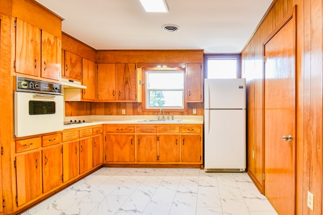 kitchen featuring white appliances and sink