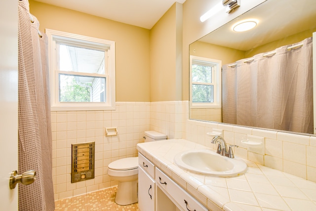 bathroom with vanity, backsplash, tile walls, toilet, and tile patterned floors