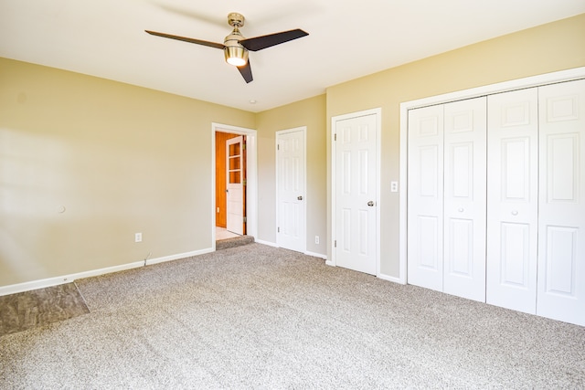 unfurnished bedroom featuring multiple closets, ceiling fan, and carpet flooring