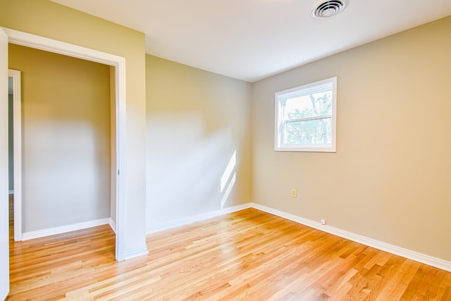 unfurnished room with light wood-type flooring