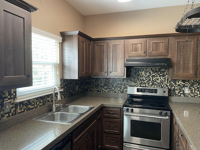 kitchen with backsplash, stainless steel range, dark brown cabinetry, and sink