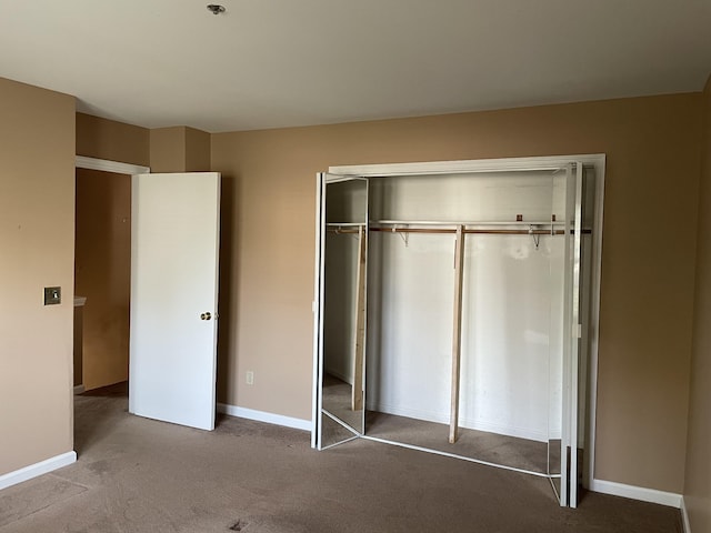 unfurnished bedroom featuring a closet and carpet