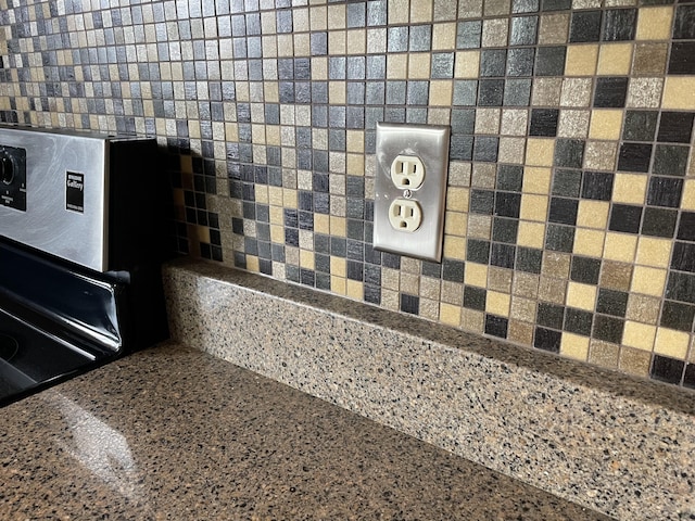 room details with decorative backsplash and stone counters