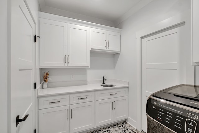 kitchen with white cabinetry and sink