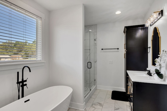 bathroom featuring vanity, a healthy amount of sunlight, and shower with separate bathtub